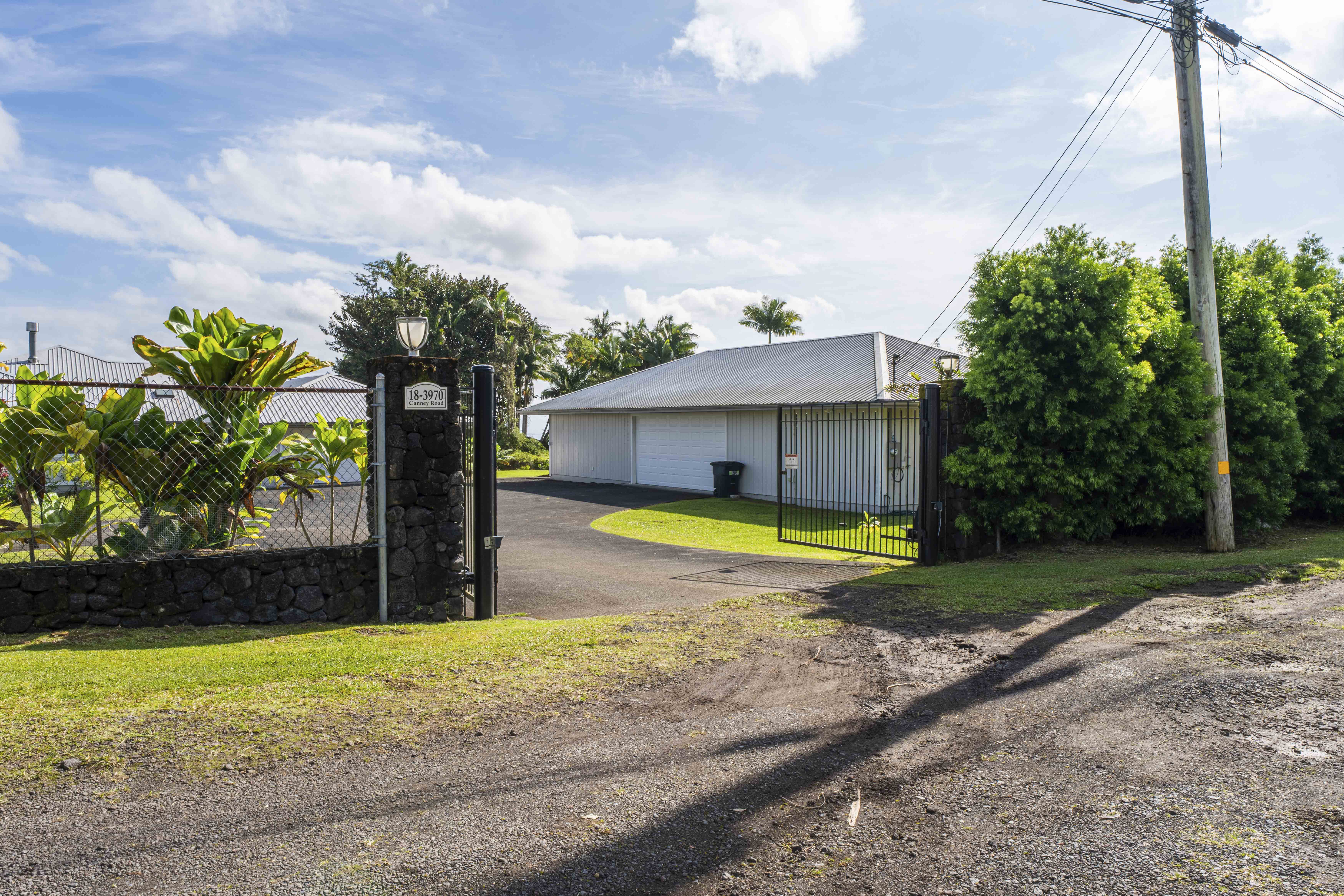 18-3970 Canney Road Mountain View, HI 96771 - Photo 26 of 30 a view of a house with swimming pool and a yard with plants