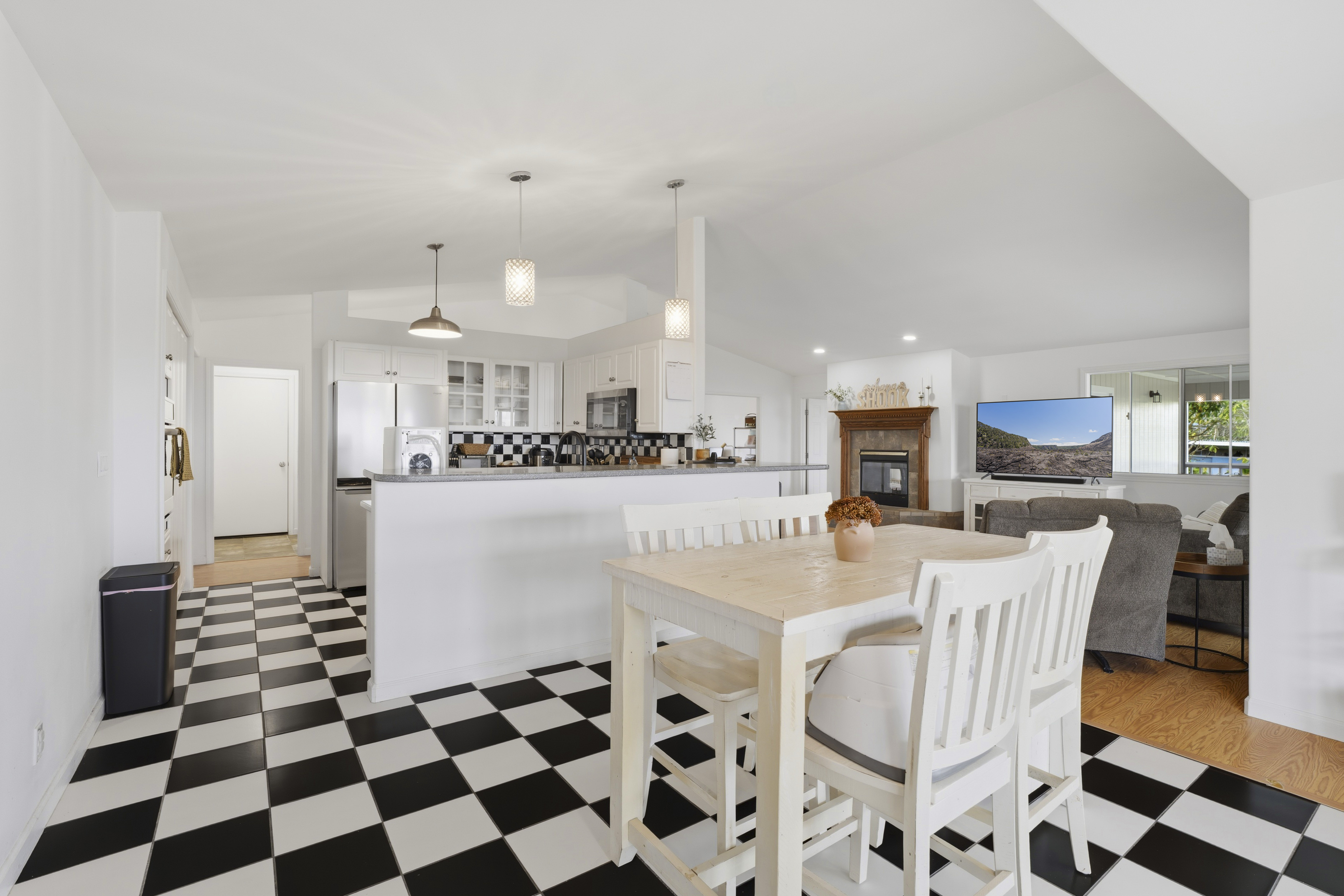 18-3970 Canney Road Mountain View, HI 96771 - Photo 10 of 30 a kitchen with stainless steel appliances kitchen island granite countertop a sink and a refrigerator