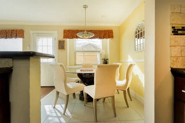 a living room with furniture a flat screen tv and kitchen view