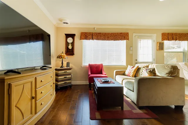 a spacious bedroom with a bed a couch and a dresser