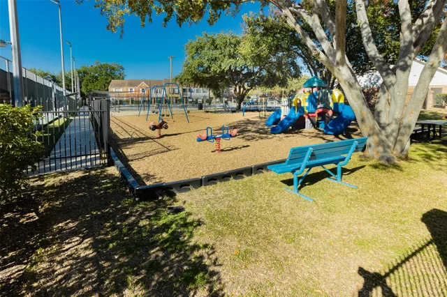a childrens park with lots of swings and slides