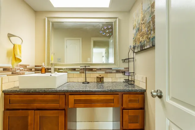 a view of a patio with a table and chairs under an umbrella