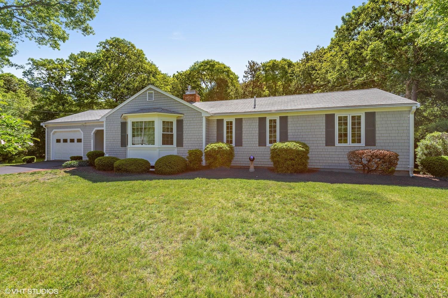 a front view of house with yard and green space