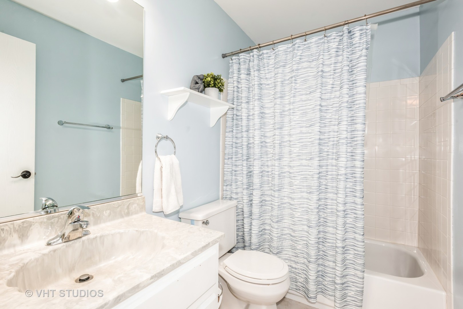 370 Ashford Circle, Unit 2 Bartlett, IL 60103 - Photo 11 of 13 a bathroom with a sink a toilet and shower curtain