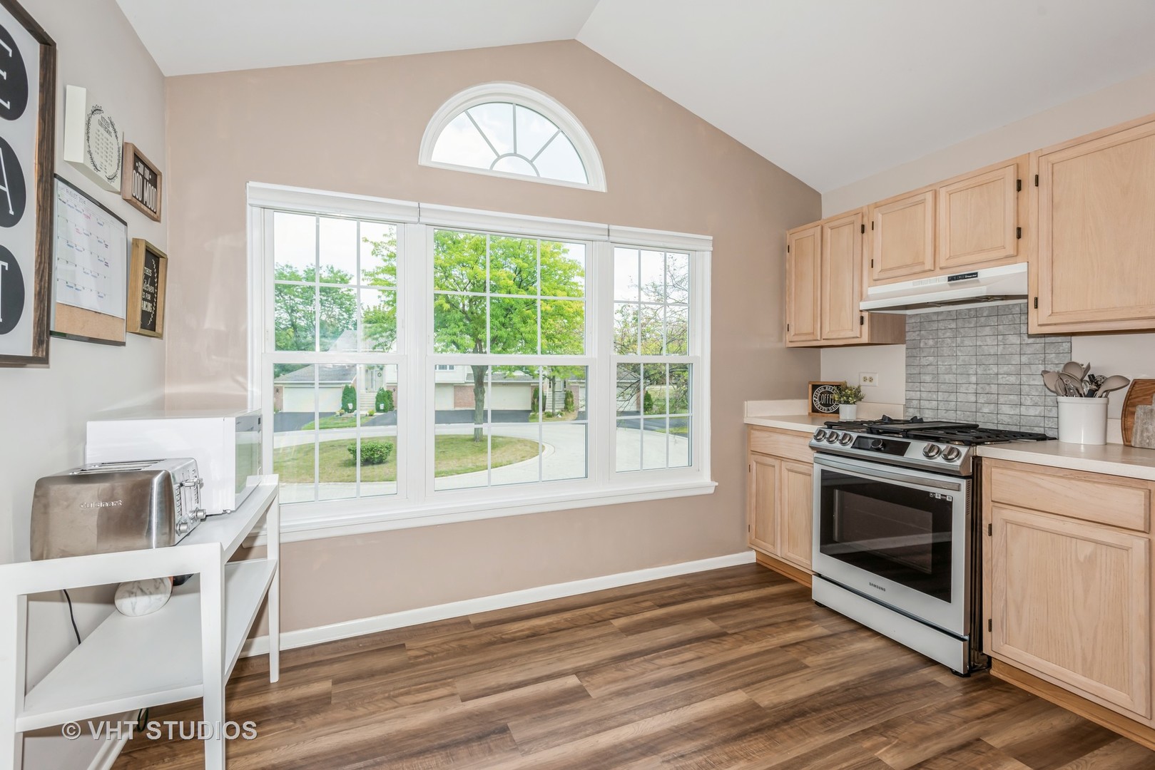 370 Ashford Circle, Unit 2 Bartlett, IL 60103 - Photo 7 of 13 a kitchen with a stove a sink and a window