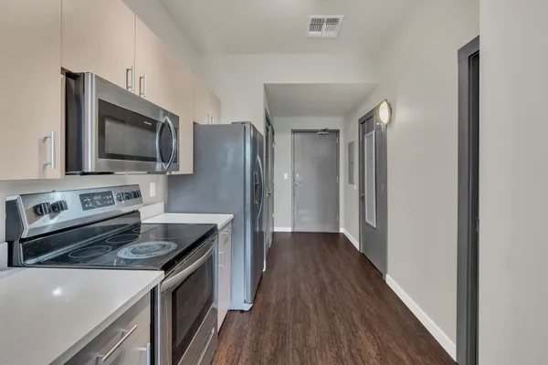 a kitchen with a stove microwave and refrigerator
