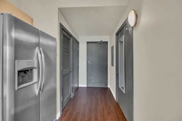 a view of a hallway with wooden floor