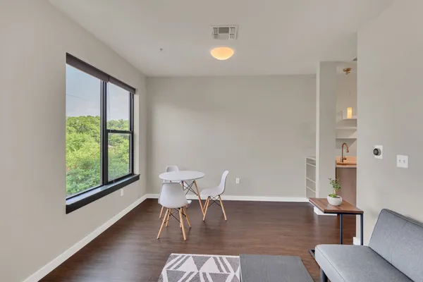 a dining room with furniture and wooden floor