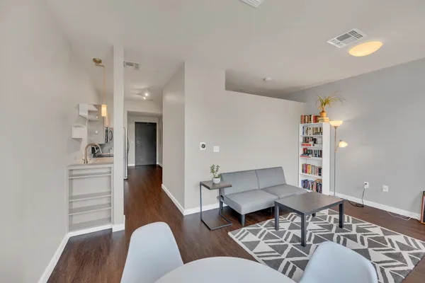 a living room with furniture a rug and a chandelier