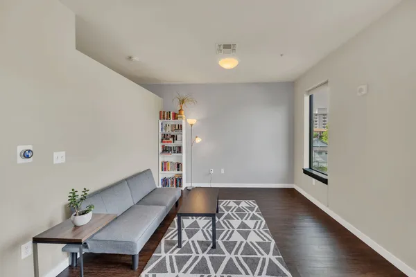 a view of room with furniture and wooden floor