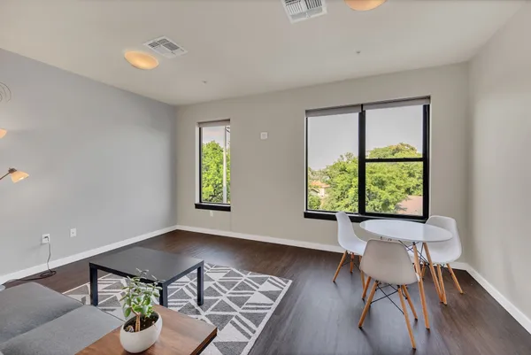 a view of a dining room with furniture window and wooden floor