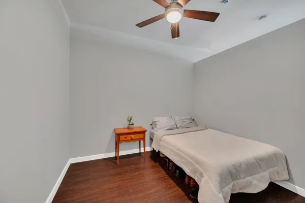 a bedroom with a bed and a chandelier