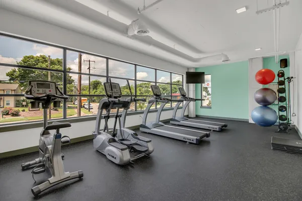 a room with gym equipment and a large window
