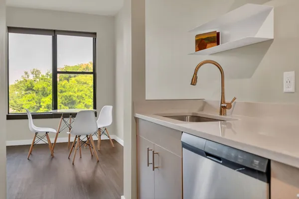 a kitchen with a sink a table and chairs