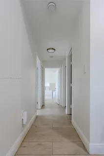 a view of a room with a sink and a mirror