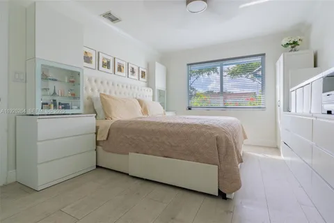 a bedroom with a bed and a cabinets