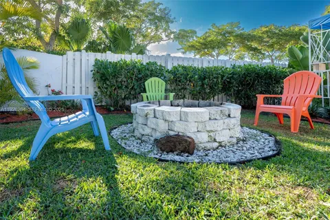 a view of an chair and table in backyard