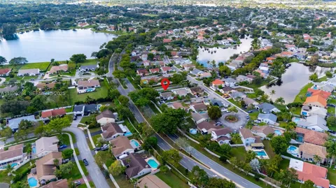 an aerial view of residential house with outdoor space and lake view
