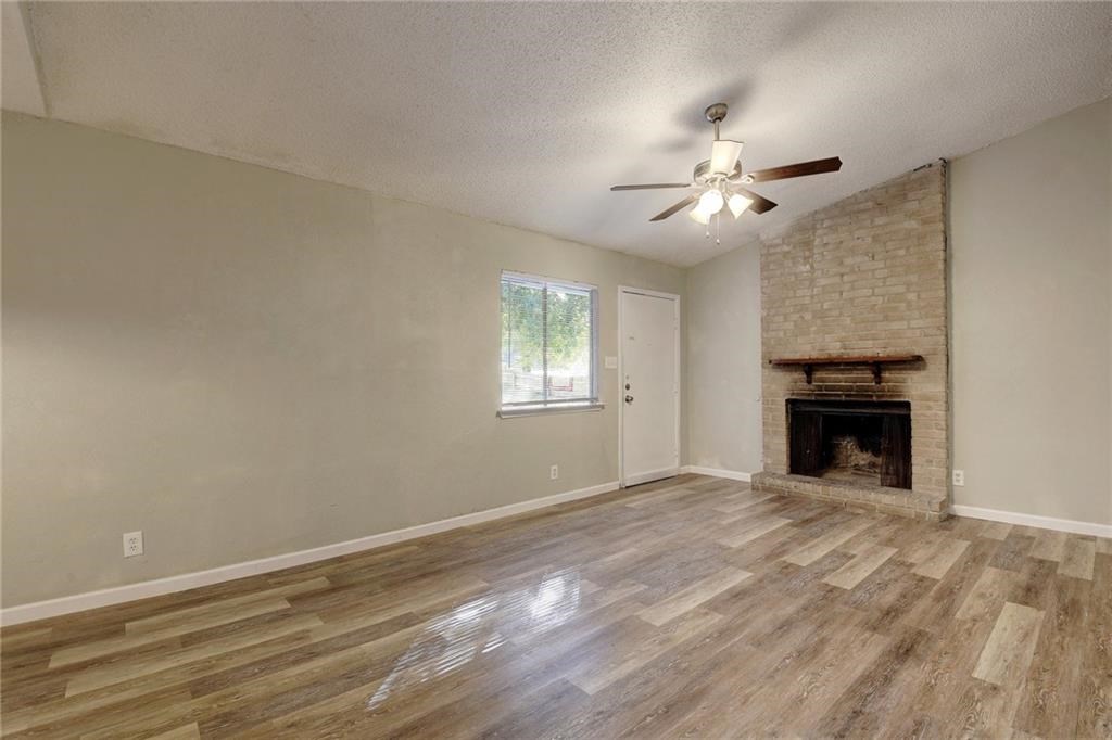 2311 Teri Road, Unit B Austin, TX 78744 - Photo 4 of 25 a view of empty room with fan and a fireplace