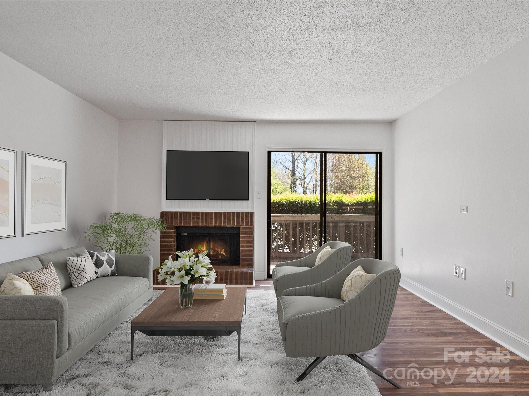 a living room with furniture a fireplace and a floor to ceiling window