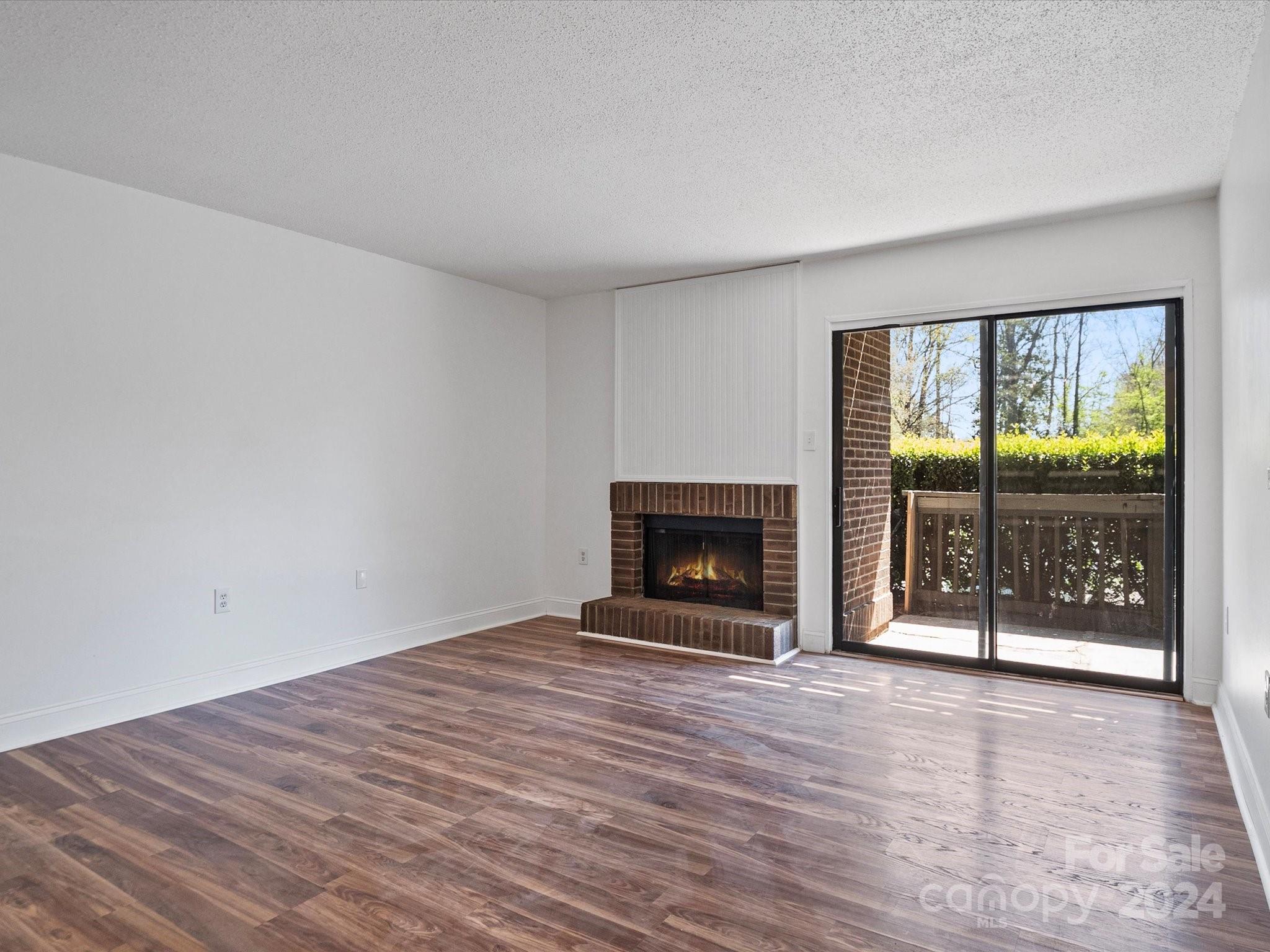 4906 Sardis Road, Unit F Charlotte, NC 28270 - Photo 12 of 30 wooden floor in a room with a fireplace