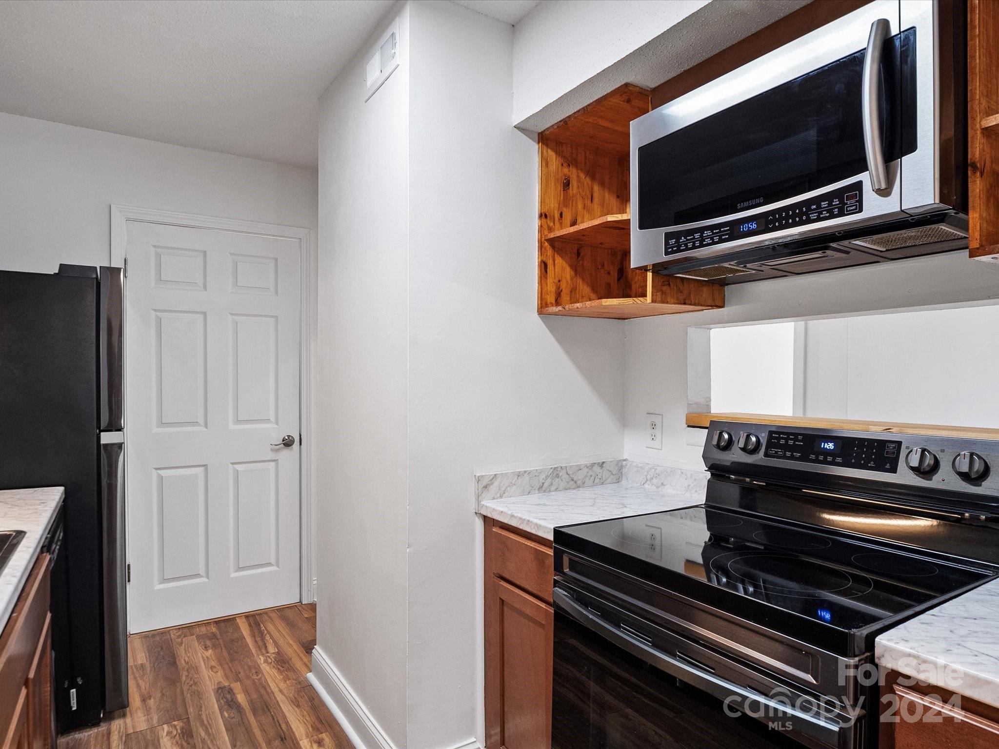 4906 Sardis Road, Unit F Charlotte, NC 28270 - Photo 15 of 30 a view of kitchen appliances and an empty room