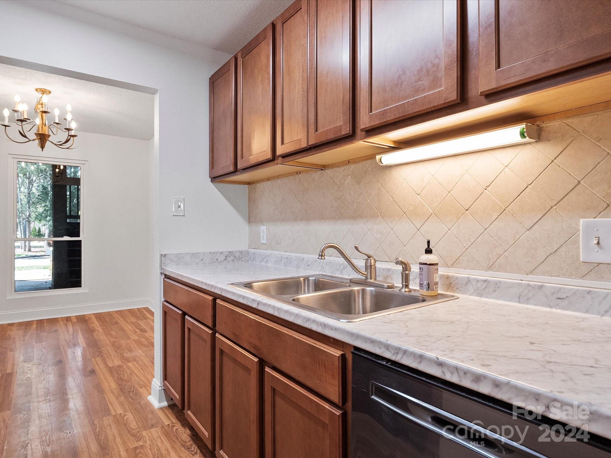 4906 Sardis Road, Unit F Charlotte, NC 28270 - Photo 17 of 30 a kitchen with a sink and cabinets