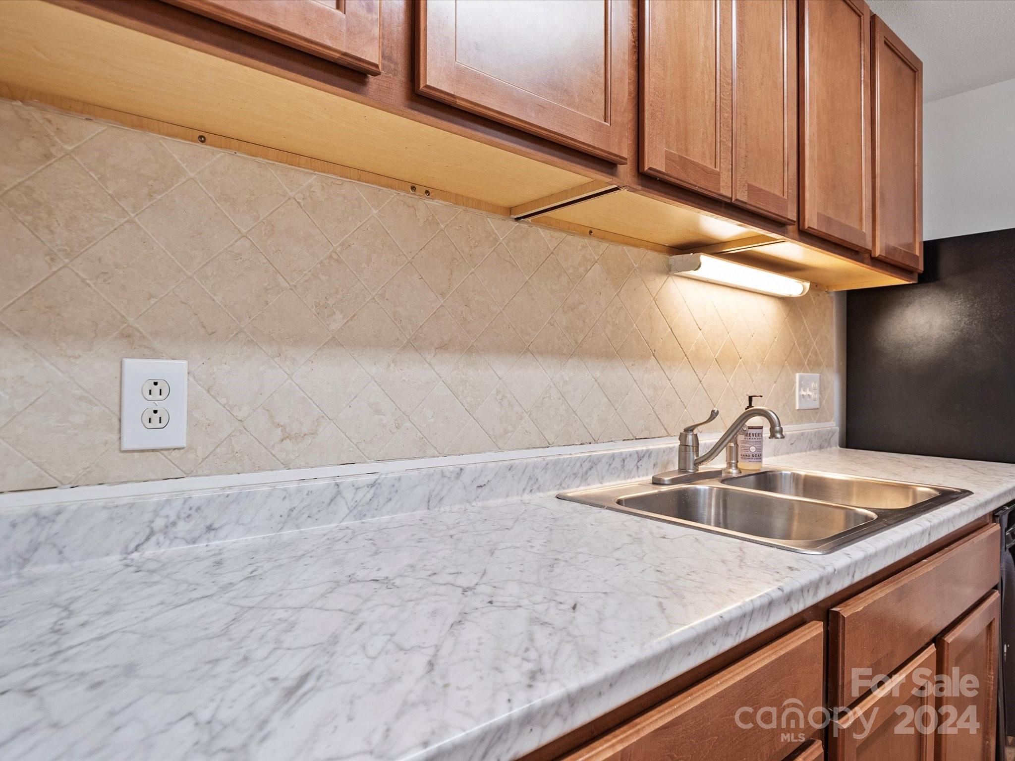 4906 Sardis Road, Unit F Charlotte, NC 28270 - Photo 19 of 30 a kitchen with a sink and cabinets