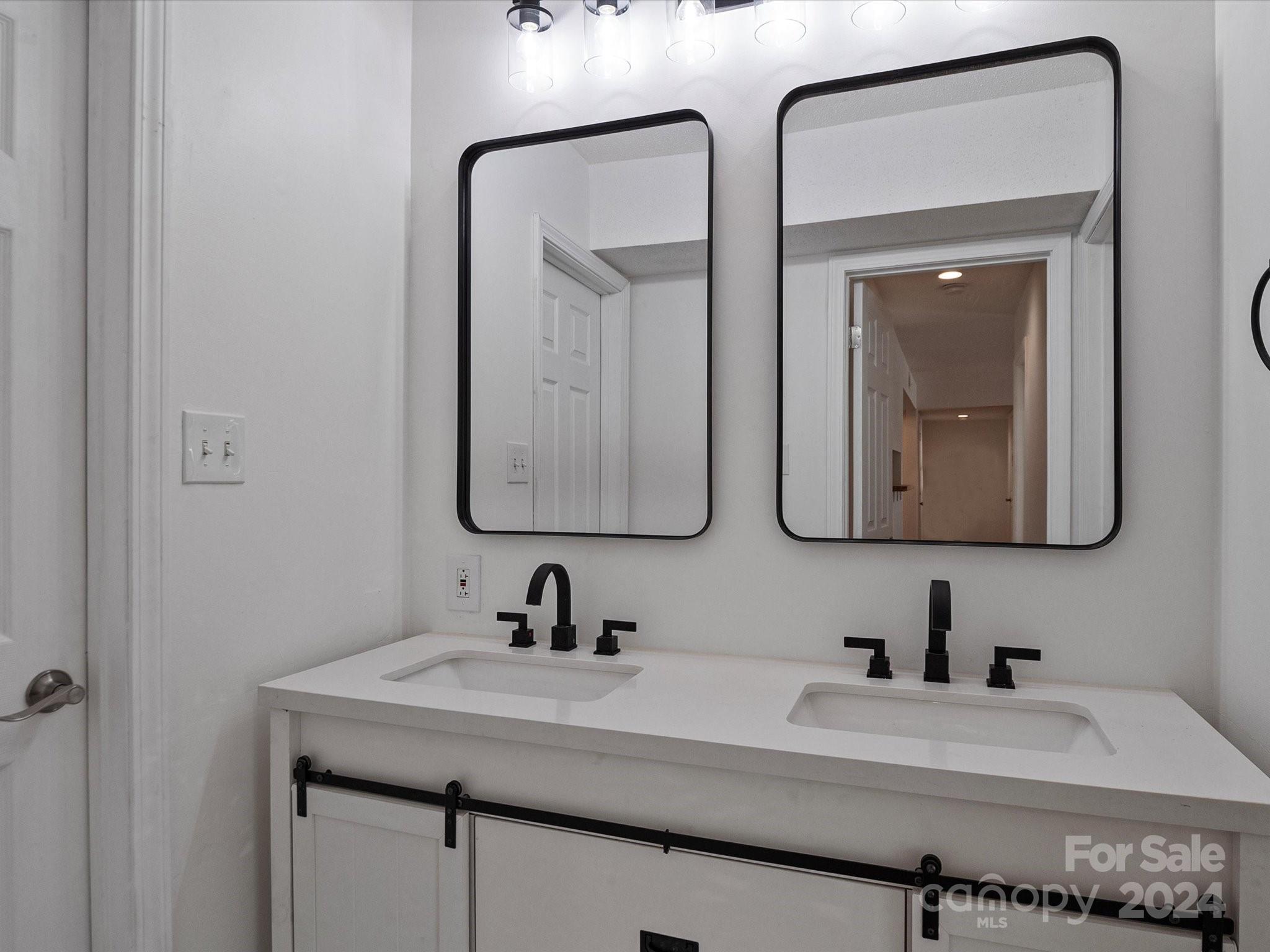 4906 Sardis Road, Unit F Charlotte, NC 28270 - Photo 23 of 30 a bathroom with a sink and a mirror