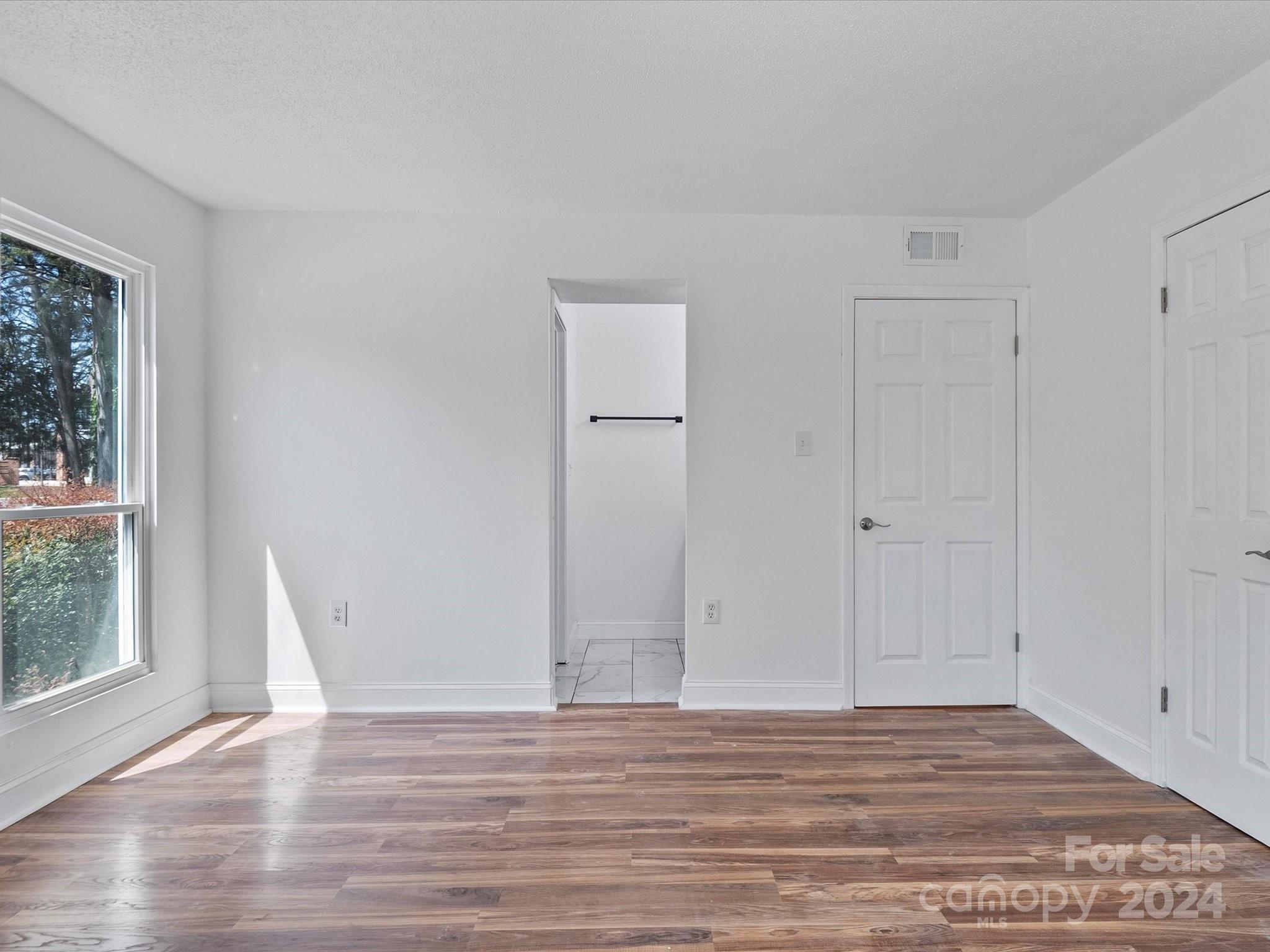 4906 Sardis Road, Unit F Charlotte, NC 28270 - Photo 25 of 30 a view of a room with wooden floor and windows