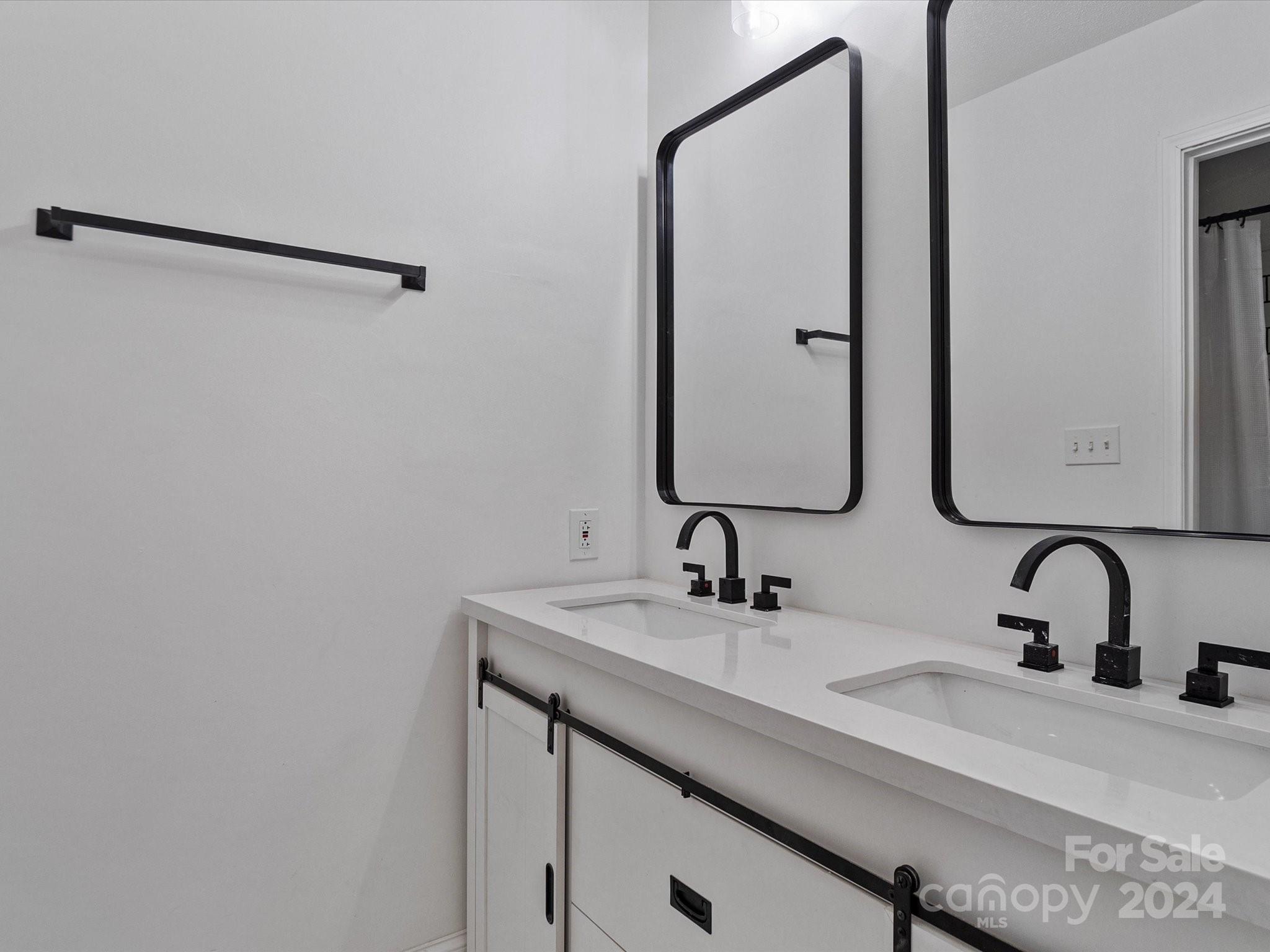 4906 Sardis Road, Unit F Charlotte, NC 28270 - Photo 27 of 30 a bathroom with a double vanity sink and a mirror