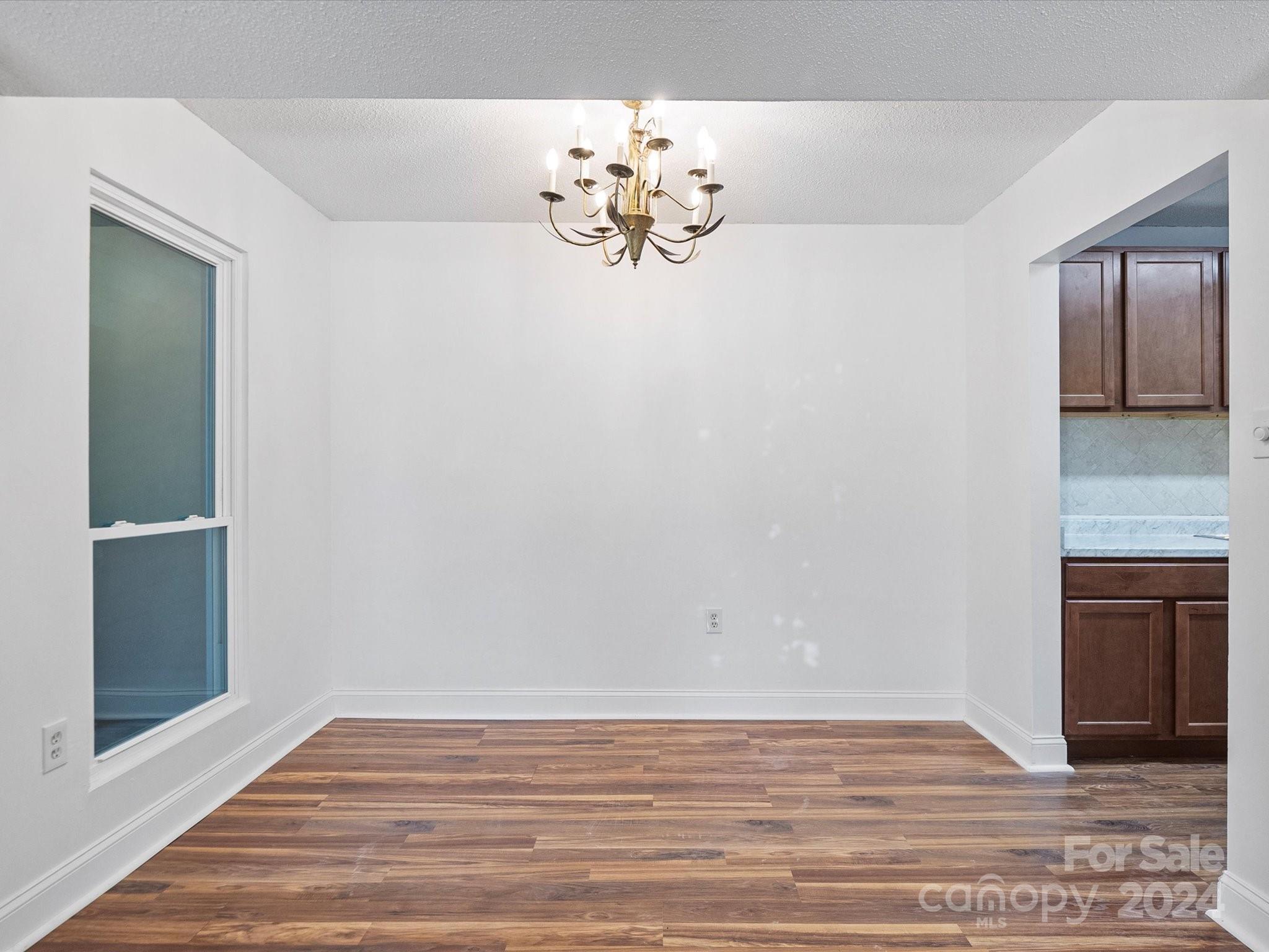 4906 Sardis Road, Unit F Charlotte, NC 28270 - Photo 10 of 30 a view of empty room with window and chandelier
