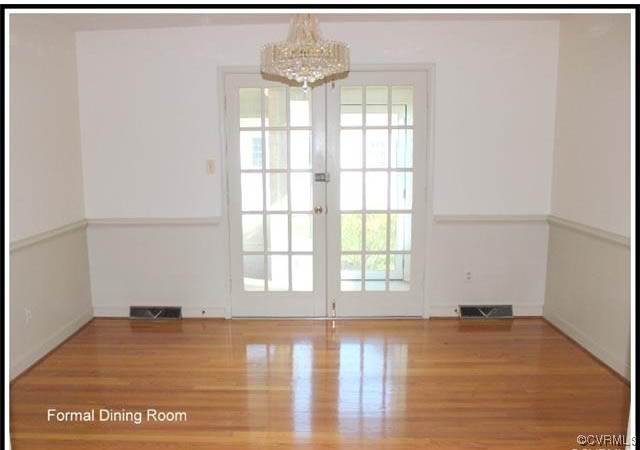 11301 Rochelle Road Chester, VA 23831 - Photo 8 of 17 an empty room with wooden floor and windows