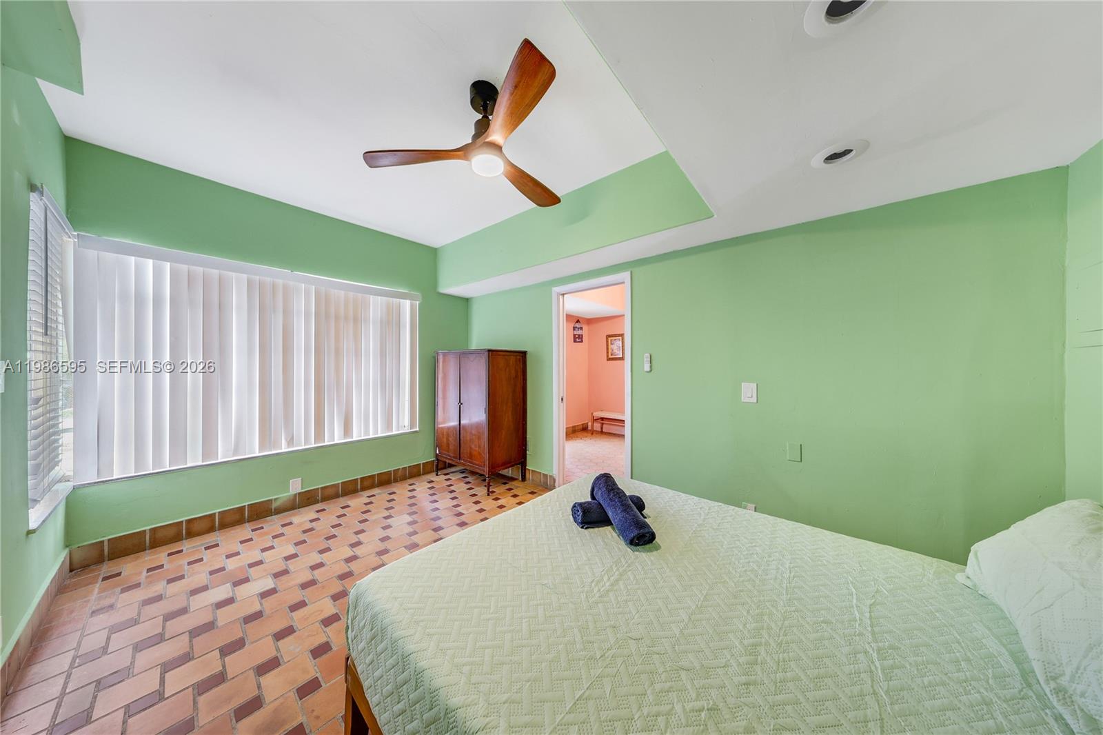 843 Northwest 3rd Street, Unit 1 Miami, FL 33128 - Photo 12 of 26 a bedroom with a bed and a chandelier