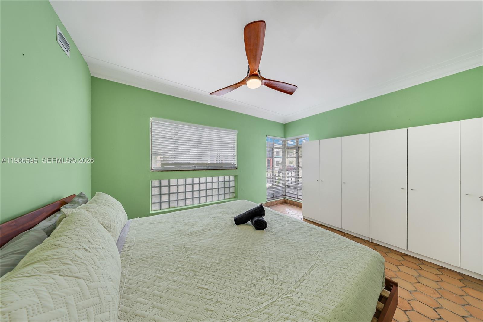 843 Northwest 3rd Street, Unit 1 Miami, FL 33128 - Photo 13 of 26 a bedroom with a bed and a large window