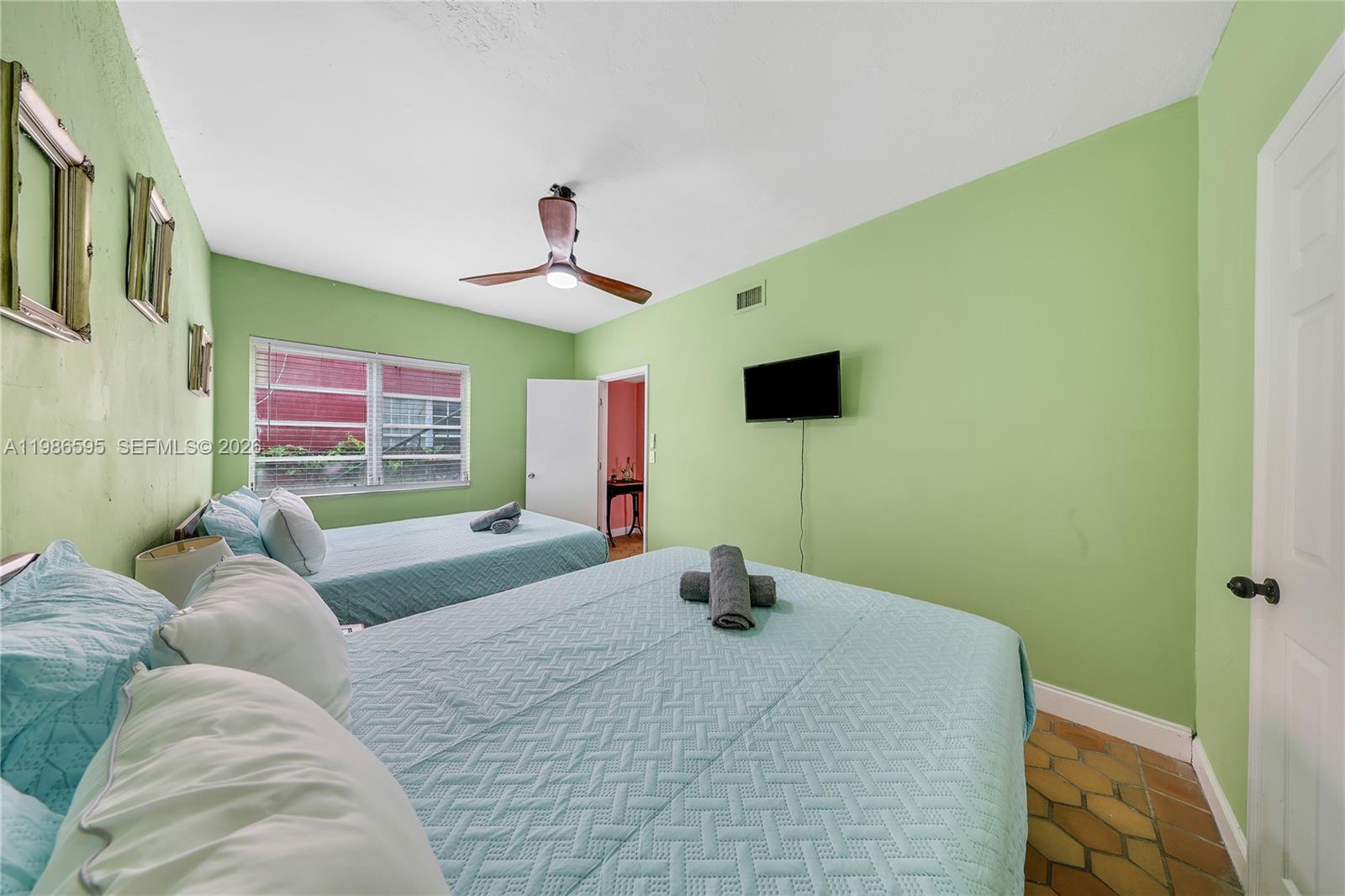 843 Northwest 3rd Street, Unit 1 Miami, FL 33128 - Photo 15 of 26 a bedroom with a bed and a window