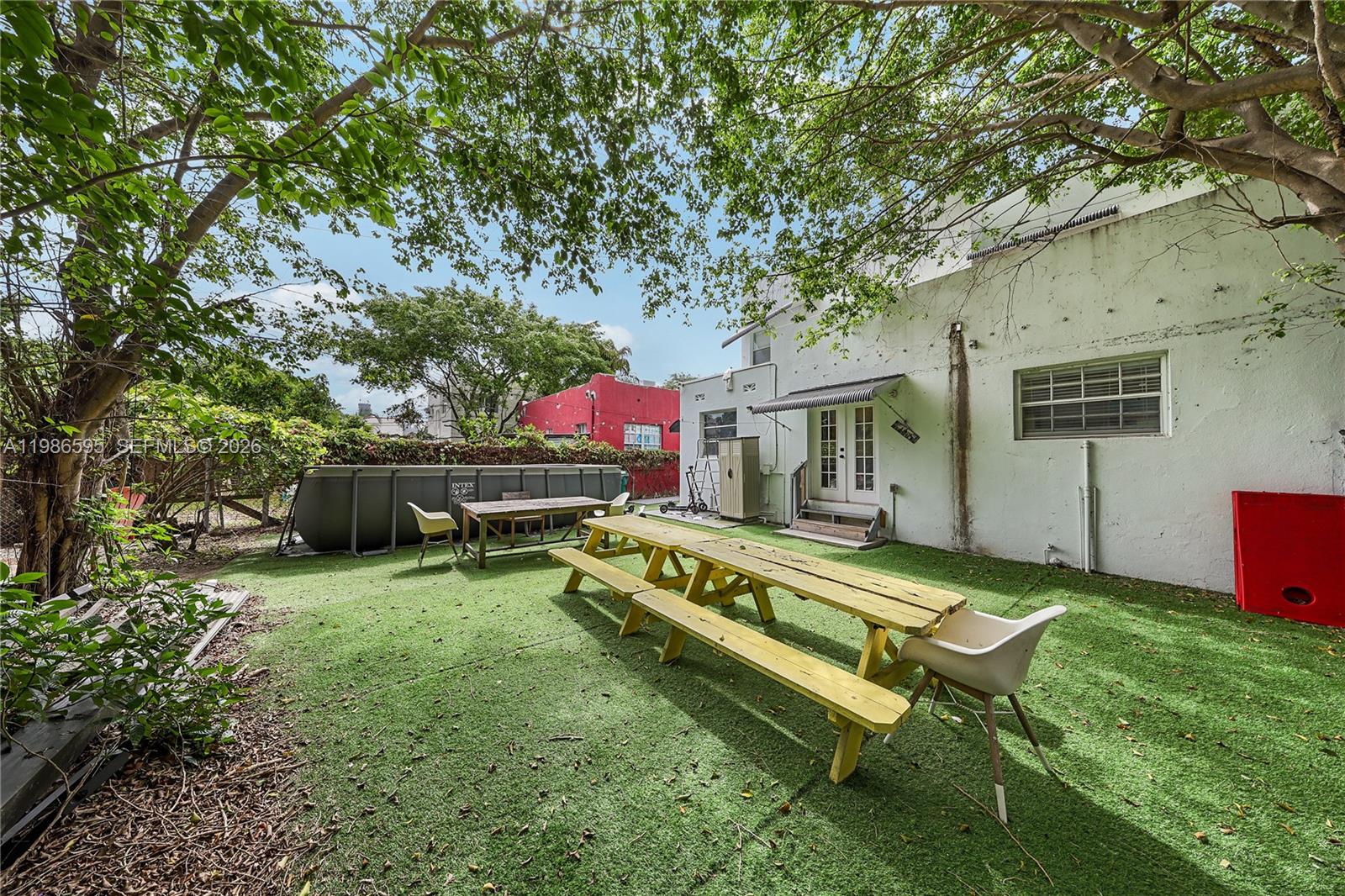 843 Northwest 3rd Street, Unit 1 Miami, FL 33128 - Photo 2 of 26 a view of a house with a backyard and a patio