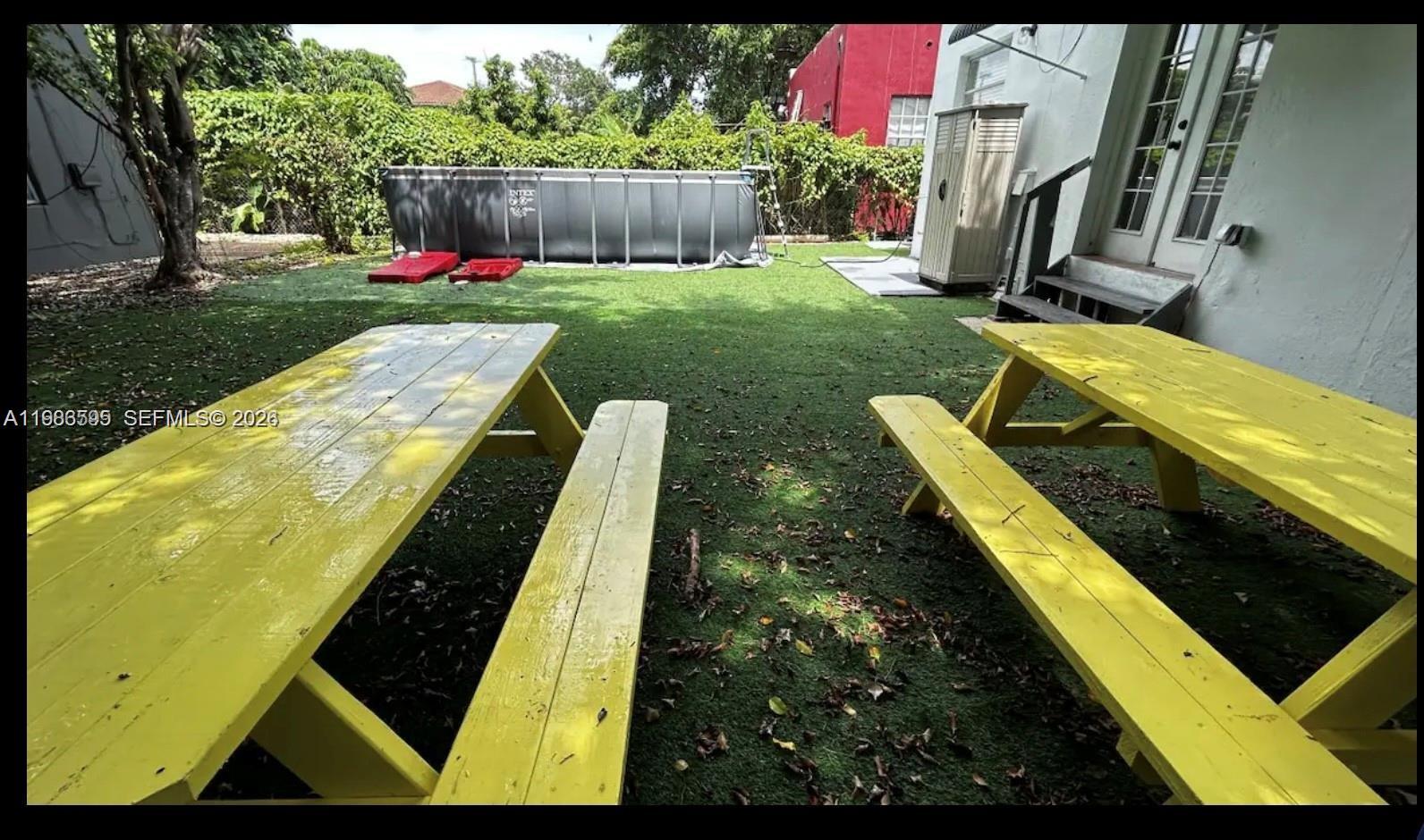 843 Northwest 3rd Street, Unit 1 Miami, FL 33128 - Photo 24 of 26 a view of backyard with swimming pool and outdoor seating