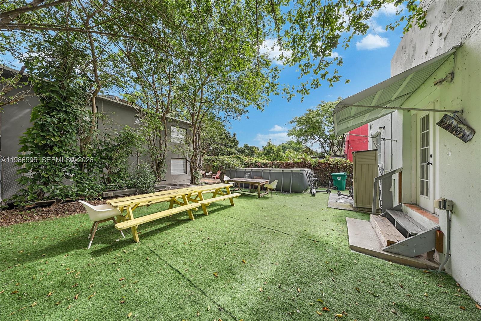 843 Northwest 3rd Street, Unit 1 Miami, FL 33128 - Photo 25 of 26 swimming pool with outdoor seating and green space