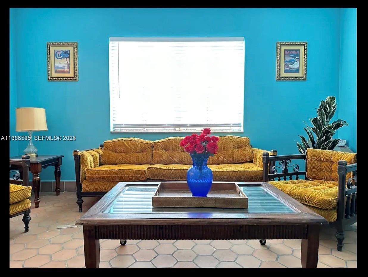 843 Northwest 3rd Street, Unit 1 Miami, FL 33128 - Photo 3 of 26 a living room with furniture and a lamp