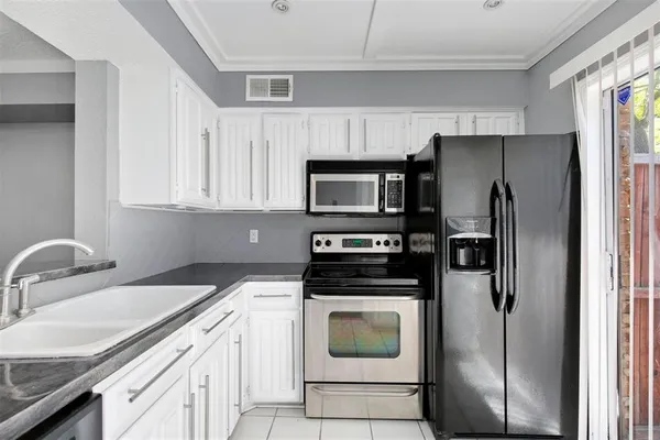 a kitchen with a refrigerator sink and microwave