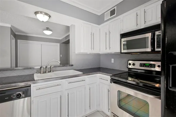 a kitchen with a sink stove and microwave
