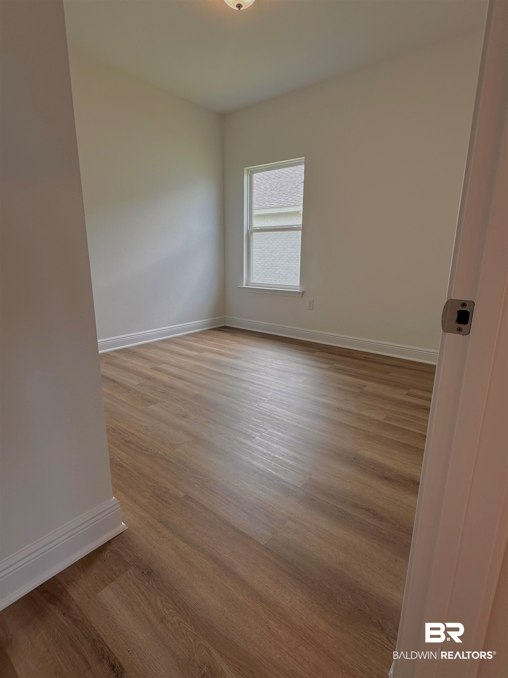 12946 Grand Rpds Road Fairhope, AL 36532 - Photo 8 of 19 Spare room with wood-type flooring
