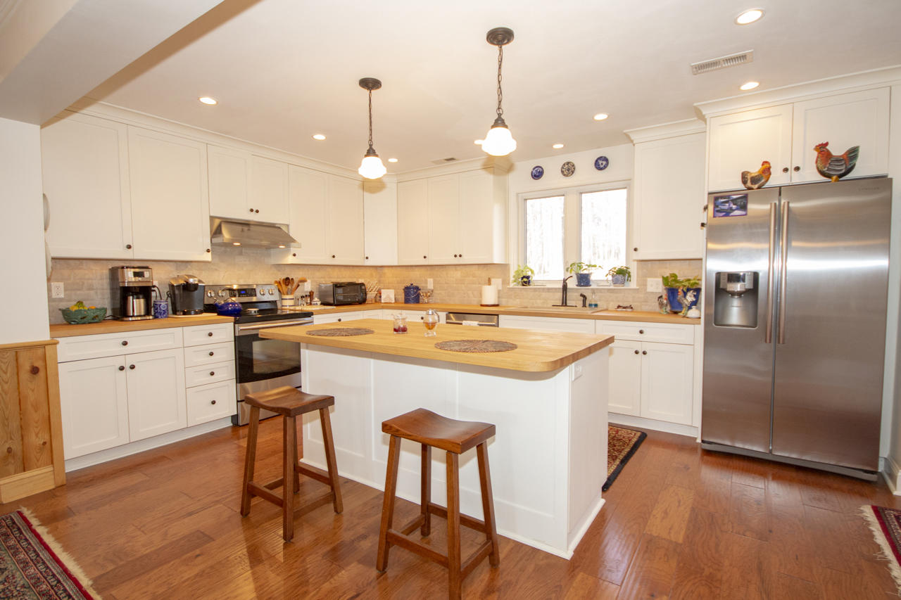 13220 West Gretna Road Sandy Level, VA 24161 - Photo 22 of 48 a kitchen with stainless steel appliances granite countertop a sink a stove a refrigerator and island with wooden floor