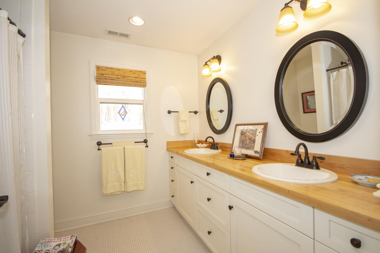 13220 West Gretna Road Sandy Level, VA 24161 - Photo 30 of 48 a bathroom with a granite countertop sink and a mirror