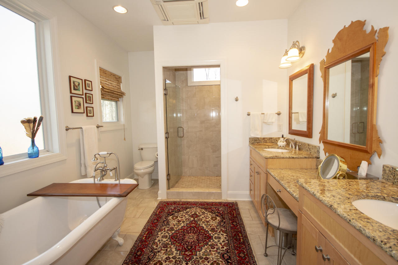 13220 West Gretna Road Sandy Level, VA 24161 - Photo 44 of 48 a spacious bathroom with a granite countertop tub sink and mirror
