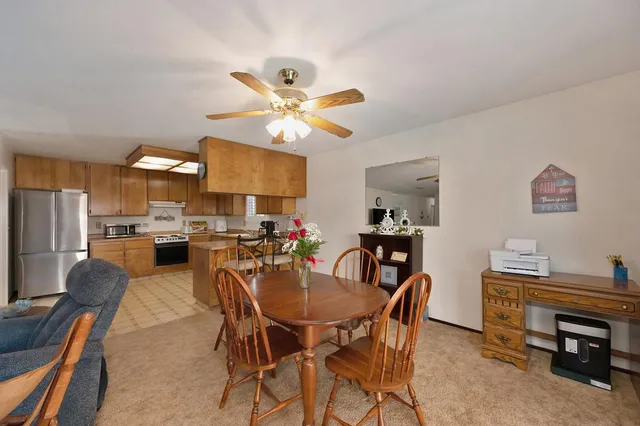 a view of a dining room with furniture and a chandelier