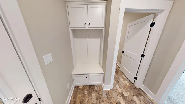 a view of an empty room and wooden floor