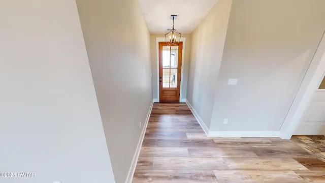 a view of hallway with wooden floor