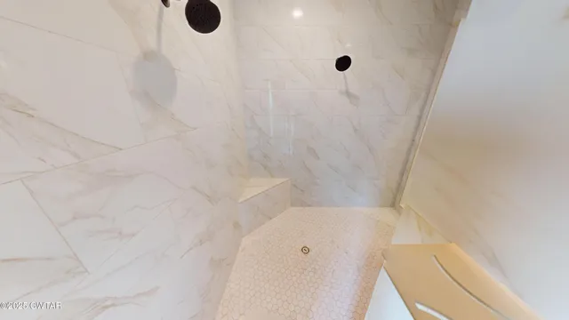 a view of a big room with windows and chandelier fan